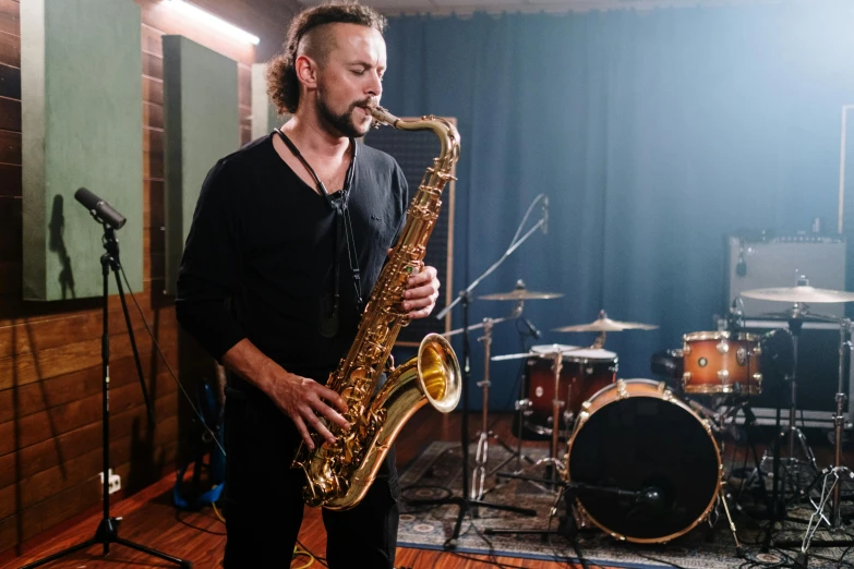 a man playing a saxophone in a music studio, lachlan bailey, profile image, frank moth, arian mark