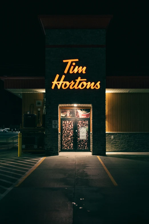 the front of a tim hortons store lit up at night, an album cover, by Tom Palin, paul barson, dark. no text, tony taka, doorway