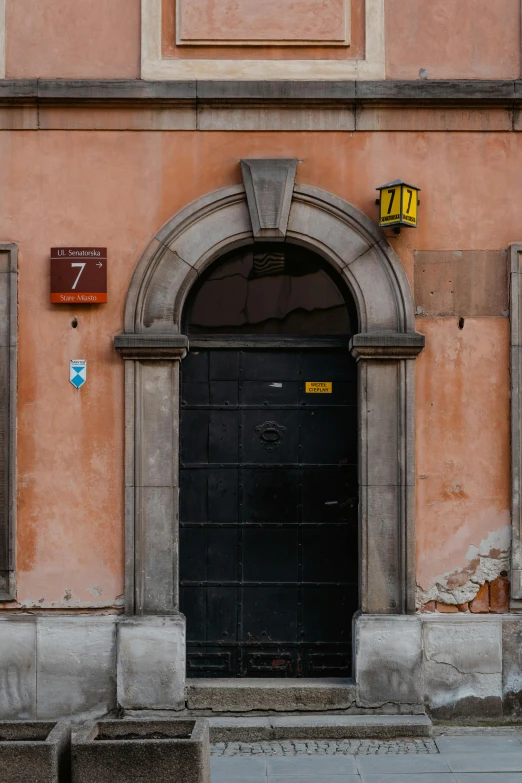 a red fire hydrant sitting in front of a building, an album cover, pexels contest winner, baroque, arched doorway, zdzislaw, black and orange, 1787