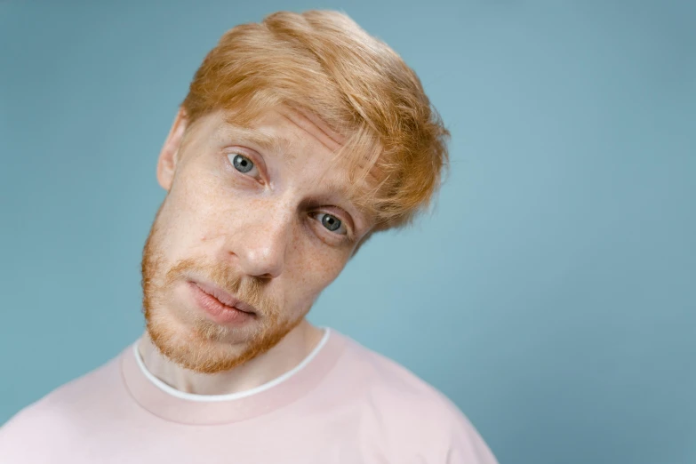 a close up of a person wearing a pink shirt, by Lee Gatch, trending on pexels, hyperrealism, ginger hair, man esthete with disgust face, pale bluish skin, looking confused
