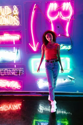 a woman standing in front of a neon sign, trending on pexels, willow smith zendaya, aesthetic lighting, nathalie emmanuel, fashion color studio lighting