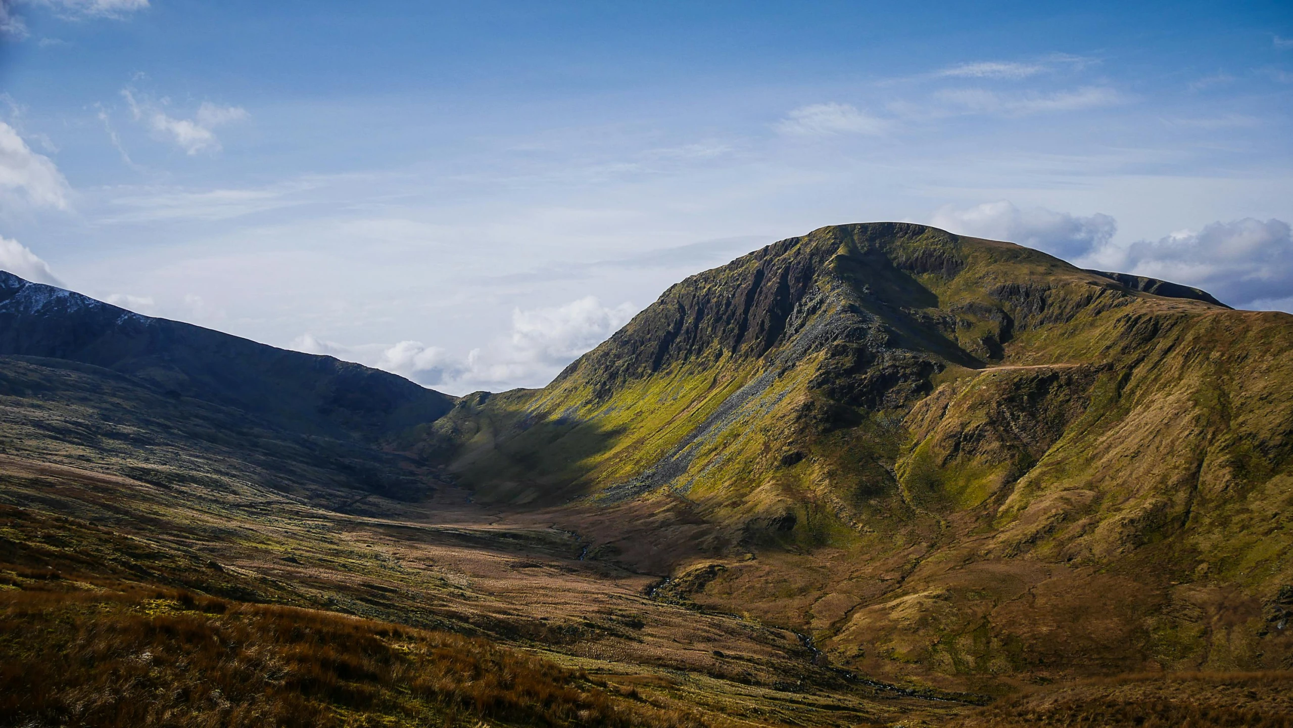 a view of a valley with mountains in the background, by Bedwyr Williams, pexels contest winner, sharp edge, slide show, sunlit, slate