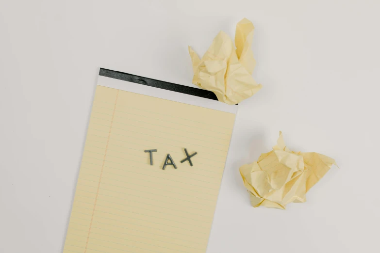 a piece of paper with the word tax written on it, by Adam Rex, pexels contest winner, conceptual art, cream paper, ikea, delete, 10k