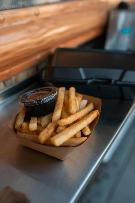 a tray of french fries sitting on top of a counter, by Jason Felix, black vertical slatted timber, daily specials, shack close up, vapor