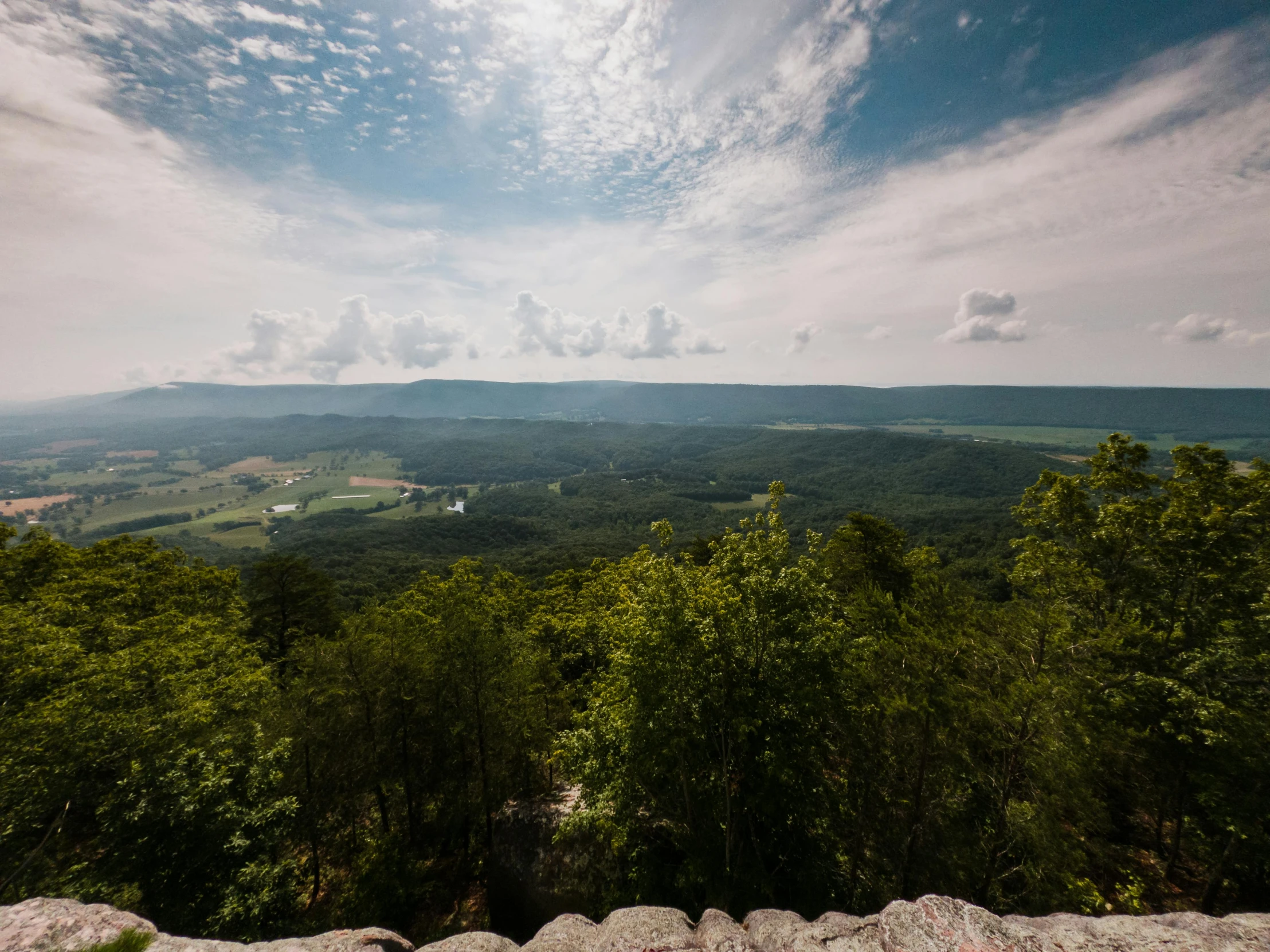 a view of a valley from the top of a mountain, unsplash contest winner, hudson river school, bentonville arkansas, lookout tower, slide show, ultrawide image