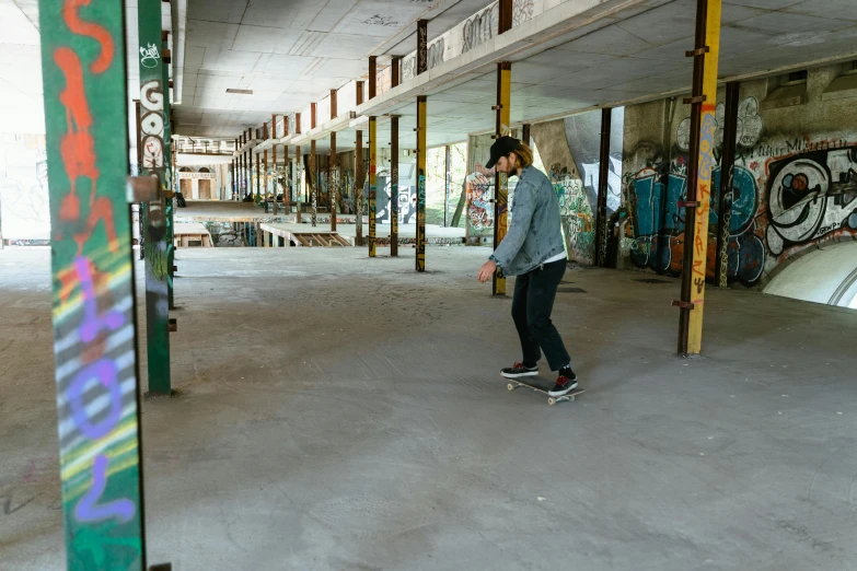 a man riding a skateboard inside of a building, ghost town, the store, graeme base, on the concrete ground