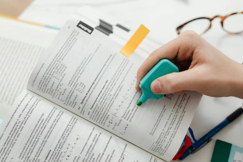 a person holding a pen over an open book, formulas, uploaded, thumbnail, educational supplies