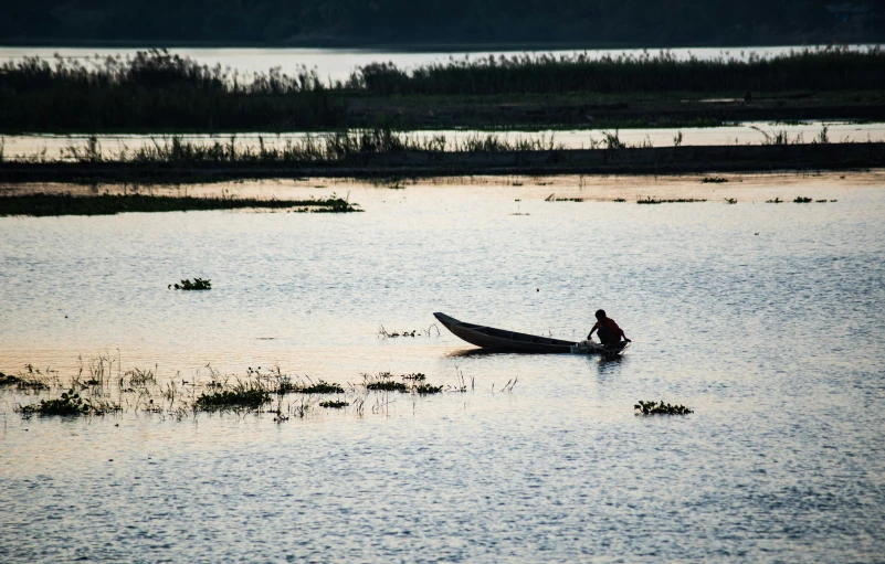 a person on a small boat in a body of water, by Jan Tengnagel, hurufiyya, best photo, lagoon, early evening, slide show