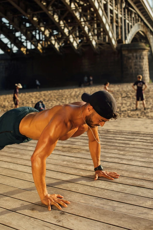 a man doing push ups on a boardwalk in front of a bridge, by Lee Gatch, figuration libre, mid-shot of a hunky, profile image, beaching, instagram story