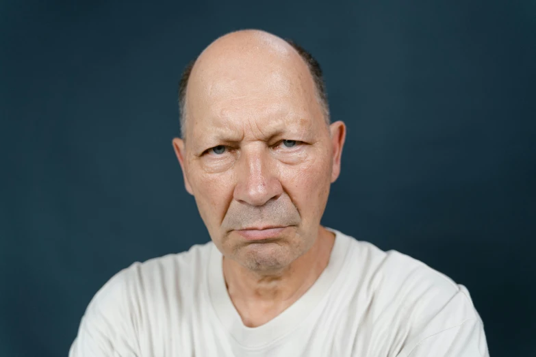 a man in a white shirt posing for a picture, a character portrait, by Peter Churcher, unsplash, hyperrealism, balding, grumpy [ old ], colour photograph, traian basescu