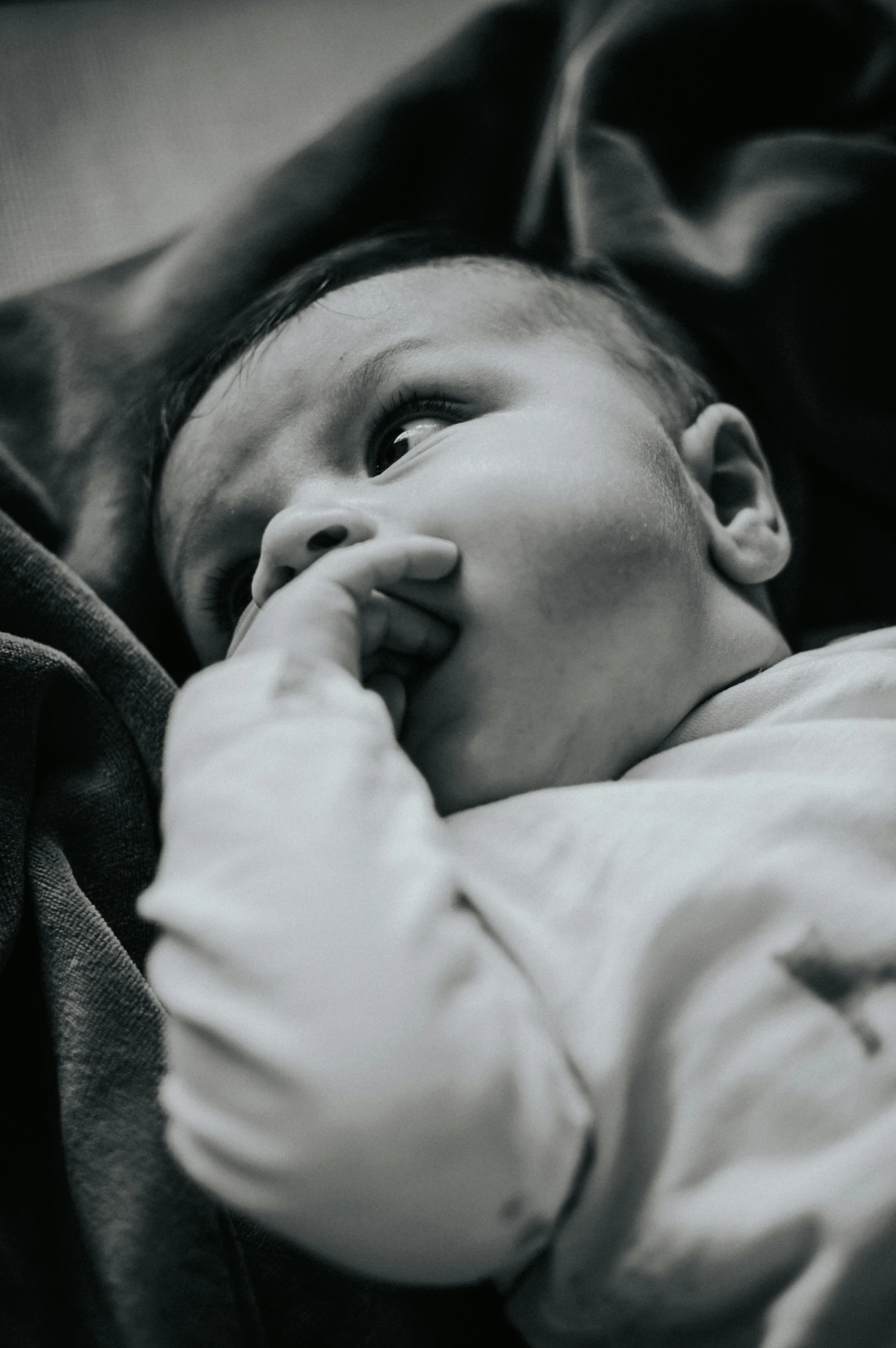 a black and white photo of a baby, pexels contest winner, happening, pondering, resting on chest, closeup portrait shot, color photo