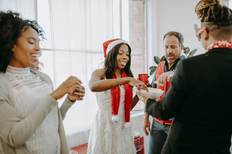 a group of people standing around each other, a photo, by Carey Morris, pexels contest winner, happening, giving gifts to people, holding a drink, silver red white details, diverse