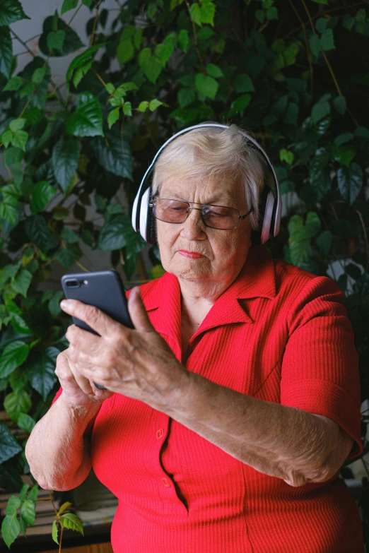 a woman wearing headphones looking at her cell phone, by Lynn Pauley, happening, an elderly, trending on spotify, album, gardening