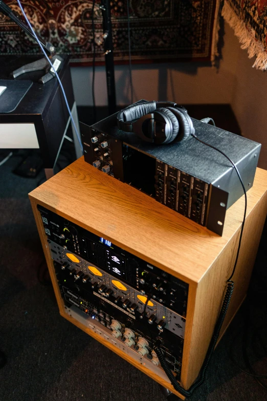 a stereo system sitting on top of a wooden table, moog modular synthesizer, headphone stand, portrait n - 9, felt