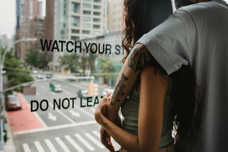 a man and a woman looking out of a window, a tattoo, trending on pexels, street art, hugging her knees, street signs, with subtitles, tattoo on shoulder