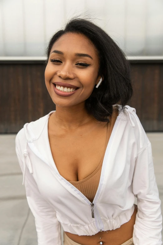 a close up of a person on a skateboard, wearing white v - neck top, smiling seductively, earbuds, sza