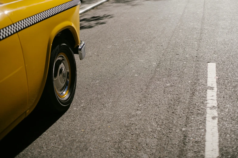 a yellow taxi cab driving down a street, unsplash, photorealism, square, low detail, wheels, nostalgic 8k