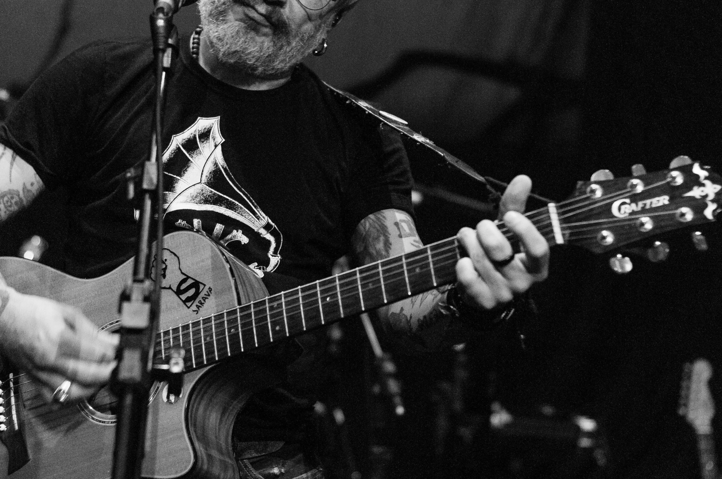 a black and white photo of a man playing a guitar, by Brian 'Chippy' Dugan, grey beard, chris bachalo, playing guitar onstage, 15081959 21121991 01012000 4k