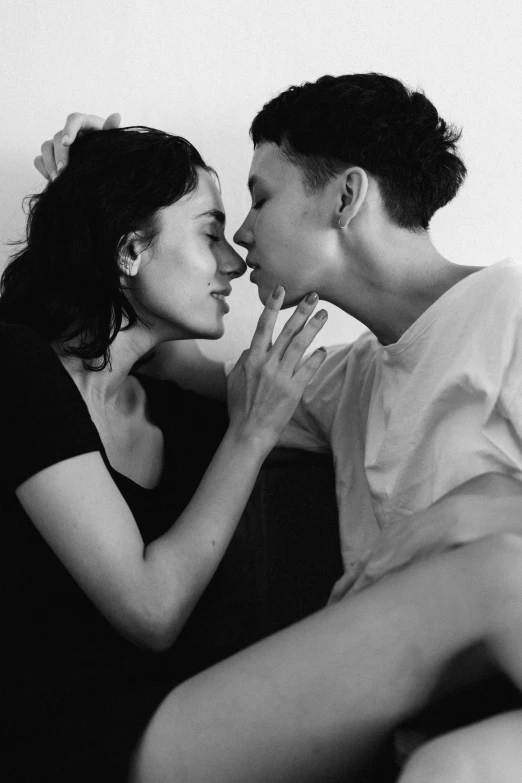 a black and white photo of a man kissing a woman, inspired by Nan Goldin, tumblr, antipodeans, nathalie emmanuel, morning. hyperrealism, two beautiful women in love, julian ope