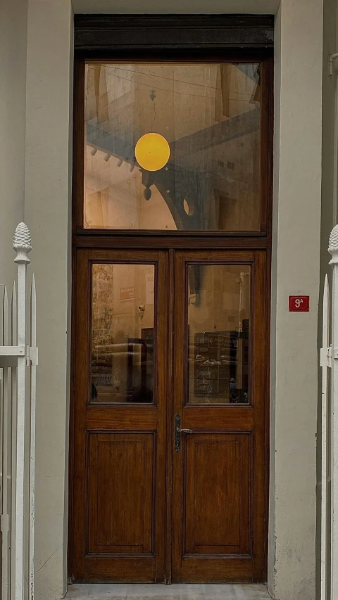 a white fire hydrant sitting in front of a wooden door, art nouveau, shaft of sun through window, taken from the high street, olafur eliasson, profile image