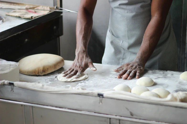 a person kneads dough on a counter in a kitchen, a portrait, trending on unsplash, ethiopian, bakery, 15081959 21121991 01012000 4k, mozzarella