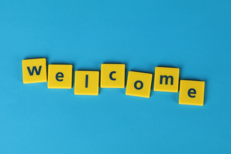 the word welcome spelled with scrabbles on a blue background, a picture, by Arabella Rankin, pexels, colors: yellow, square, electronic components, 1960s-era