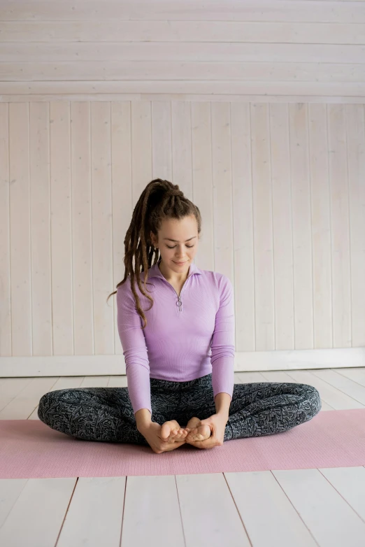 a woman sitting on top of a pink yoga mat, pexels contest winner, renaissance, tight bun, young teen, sitting cross-legged, forward facing