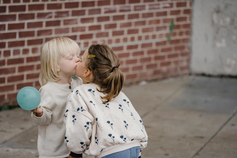 a couple of little girls standing next to each other, by Emma Andijewska, pexels contest winner, graffiti, lesbian kiss, ignant, pure joy, health