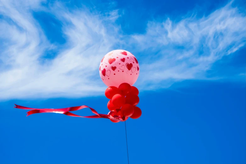 a bunch of red and white balloons floating in the air, by Julia Pishtar, pexels contest winner, romanticism, bright blue sky, red ribbon, 15081959 21121991 01012000 4k, cupid