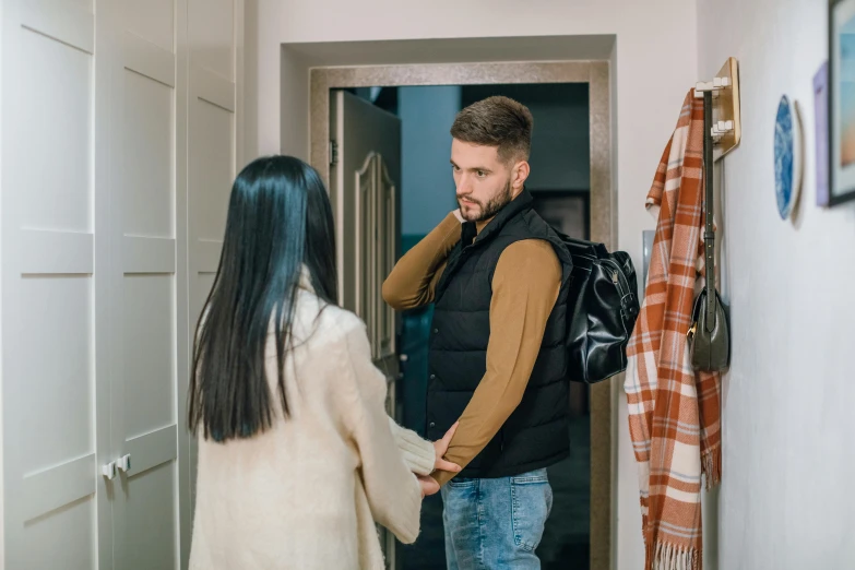 a man standing next to a woman in a hallway, scamming, profile image, fall season, standing outside a house