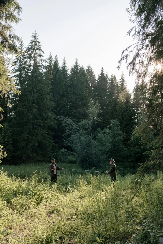 a couple of people that are standing in the grass, an album cover, by Tobias Stimmer, unsplash, boreal forest, fishing, wide film still, adim kashin