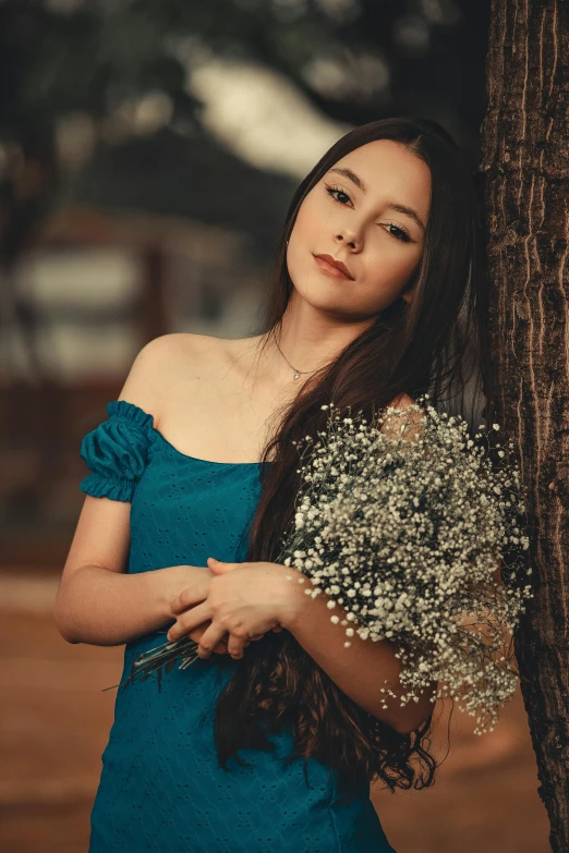 a woman in a blue dress holding a bunch of flowers, inspired by Elsa Bleda, pexels contest winner, asian girl with long hair, album cover, beautiful young himalayan woman, #trending