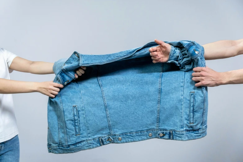 a man and a woman holding a blue jean jacket, trending on unsplash, hyperrealism, opening, thick lining, on a pale background, cloth jerkin