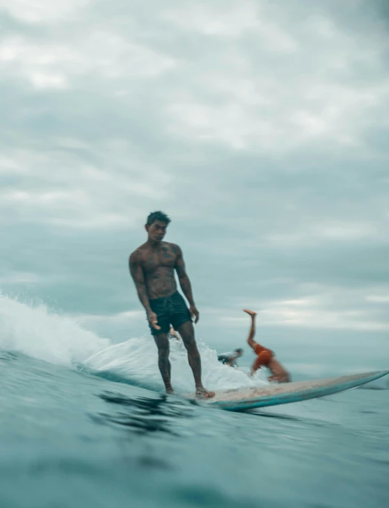 a man riding a wave on top of a surfboard, a polaroid photo, pexels contest winner, renaissance, bowater charlie and brom gerald, philippines, friendly guy and small creature, photo for vogue