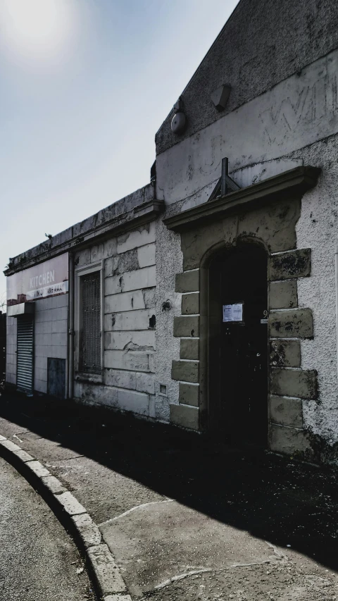 a man riding a skateboard down a street next to a building, an album cover, by Lee Loughridge, unsplash, graffiti, abandoned cottage, old shops, doorway, museum photo