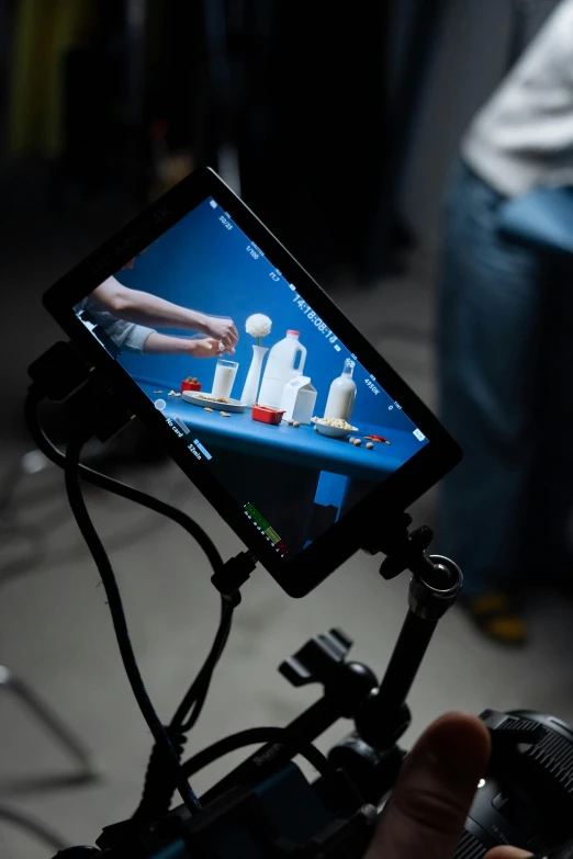 a close up of a person holding a camera, video art, using a magical tablet, photographed for reuters, sketchfab », center focus on table