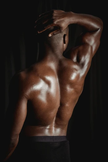a man standing with his back to the camera, inspired by Robert Mapplethorpe, pexels contest winner, renaissance, dark brown skin, huge glistening muscles, light-brown skin, dark taint :: athletic
