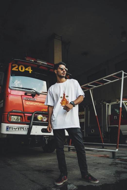 a man standing in front of a fire truck, pexels contest winner, graffiti, plain white tshirt, japanese streetwear, single body, yoshitaka