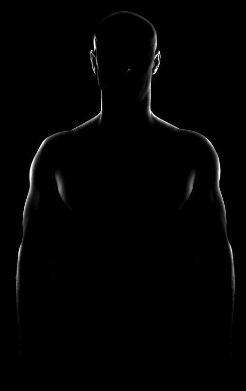 a silhouette of a man in the dark, a black and white photo, by Andrew Domachowski, digital art, defined muscles, silhouette :7, human - shaped, backround dark