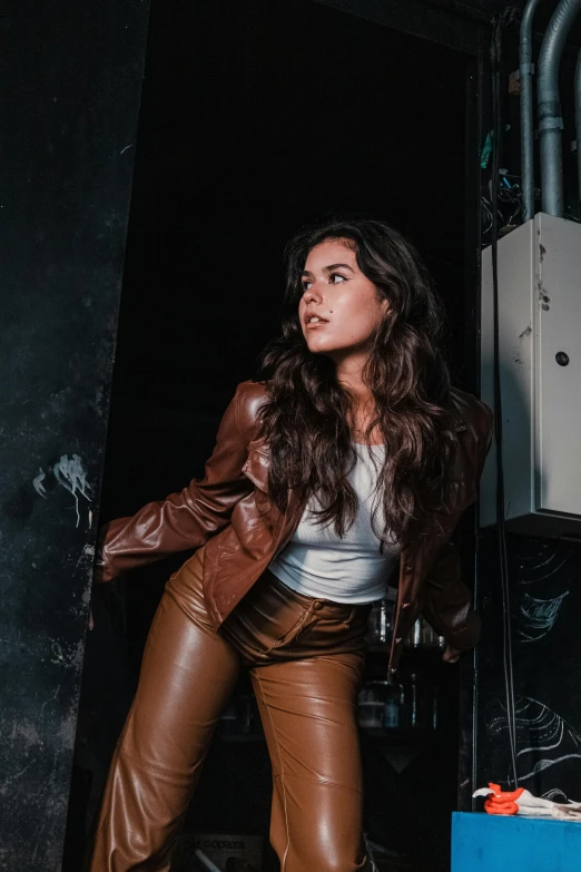 a woman in leather pants and a leather jacket, an album cover, by Robbie Trevino, trending on pexels, brown long hair, indoor picture, actress, profile pic