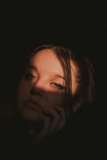 a close up of a person with a cell phone, an album cover, inspired by Elsa Bleda, trending on pexels, realism, portrait sophie mudd, pensive lonely, dark scene with dim light, low quality photo