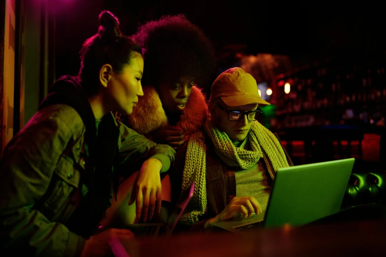 a couple of women sitting next to each other on a laptop, by Joe Bowler, pexels, renaissance, photograph of three ravers, taverns nighttime lifestyle, 3 actors on stage, programming