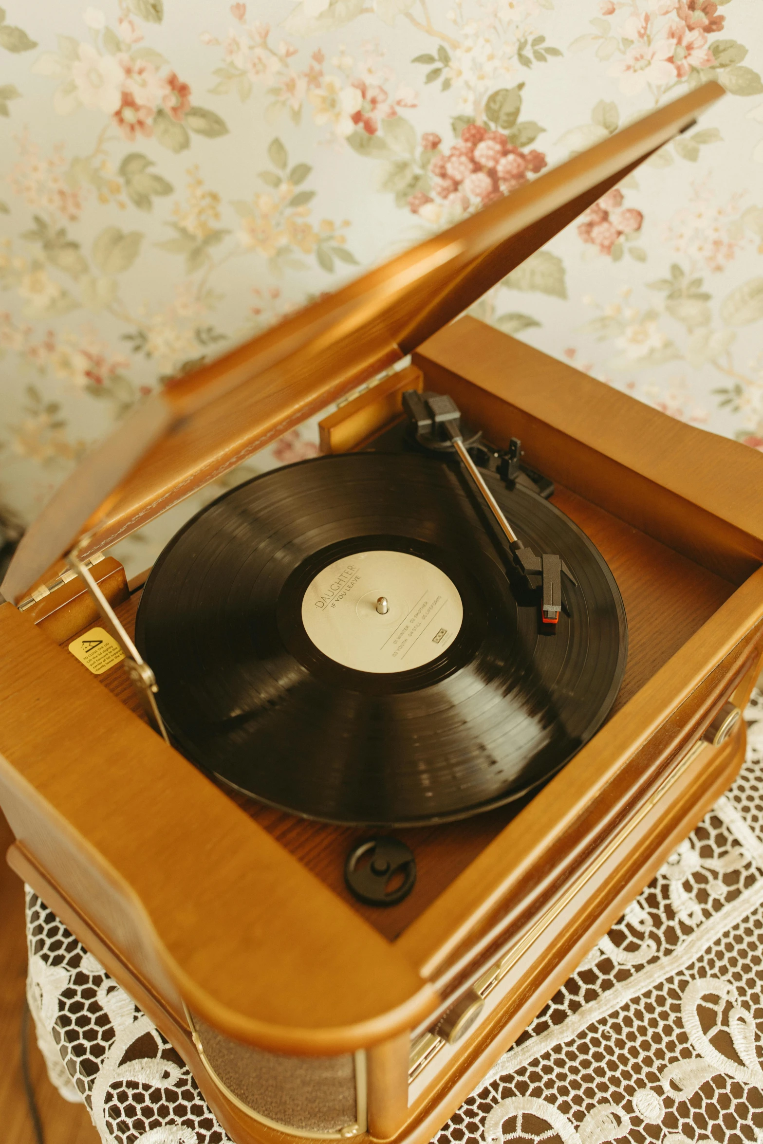 a record player sitting on top of a wooden table