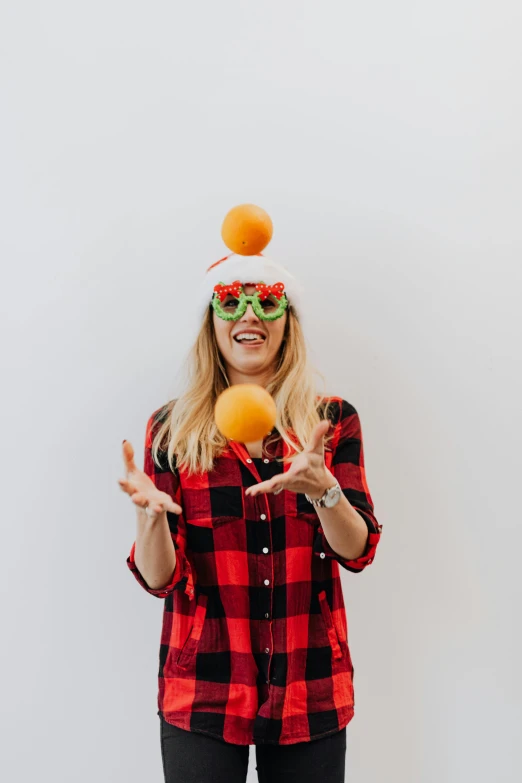 a woman balancing an orange on her head, pexels contest winner, hanging out with orbs, 2 5 6 x 2 5 6 pixels, red nose, goggles on forehead