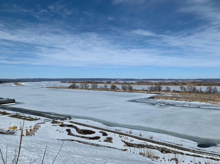 a man riding skis on top of a snow covered slope, a picture, pexels contest winner, land art, scenic view of river, from wheaton illinois, wide long view, (3 are winter