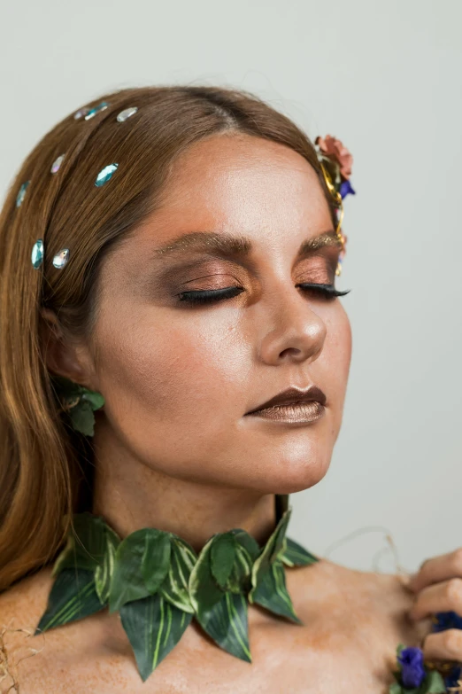 a close up of a woman with flowers in her hair, an album cover, inspired by Maties Palau Ferré, natural make-up, iridescent metals, ivy vine leaf and flower top, beetle-inspired