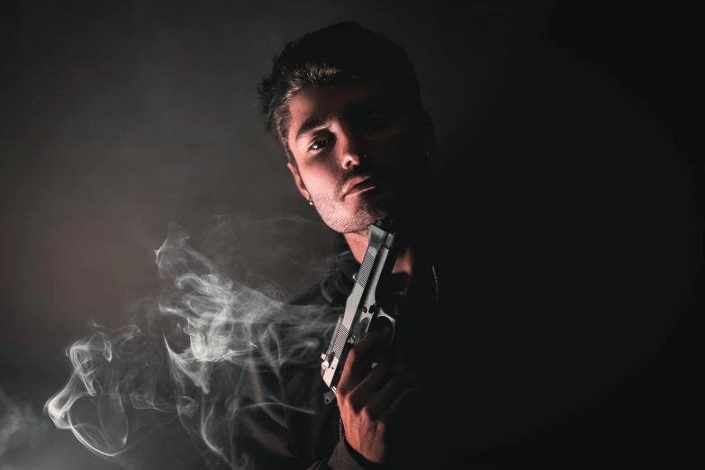 a man holding a gun in the dark, a portrait, pexels contest winner, realism, smoke in the background, avatar image, model posing, headshot profile picture