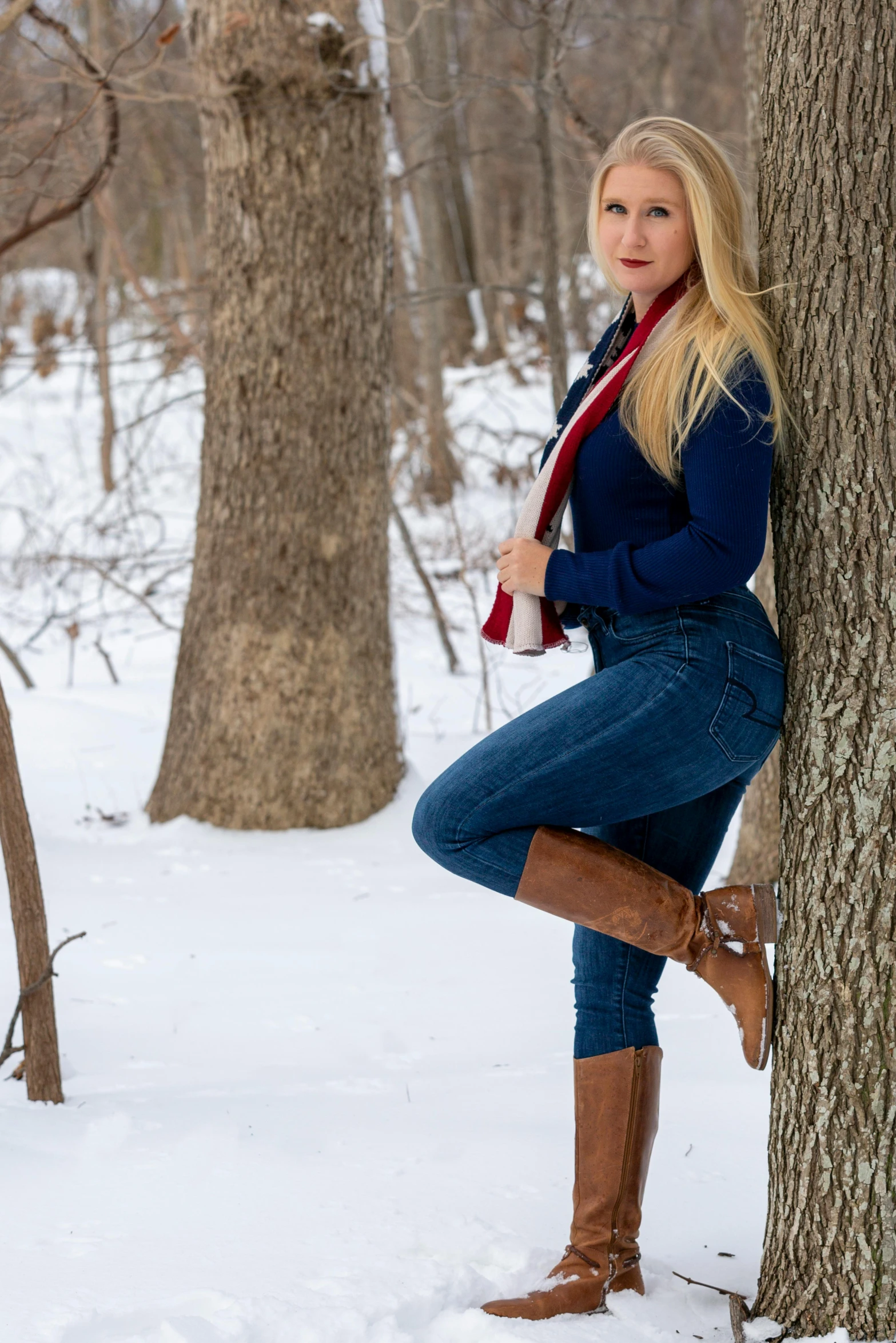 a woman leaning against a tree in the snow, blue jeans, modeling shoot, taken in 2 0 2 0, f / 2 0