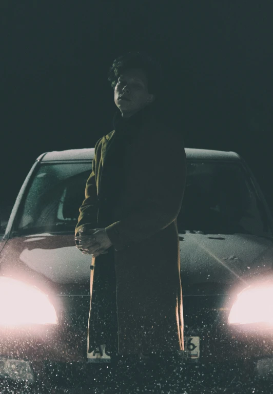 a man standing in front of a car at night, an album cover, profile image, dark. no text, ansel ], confident stance