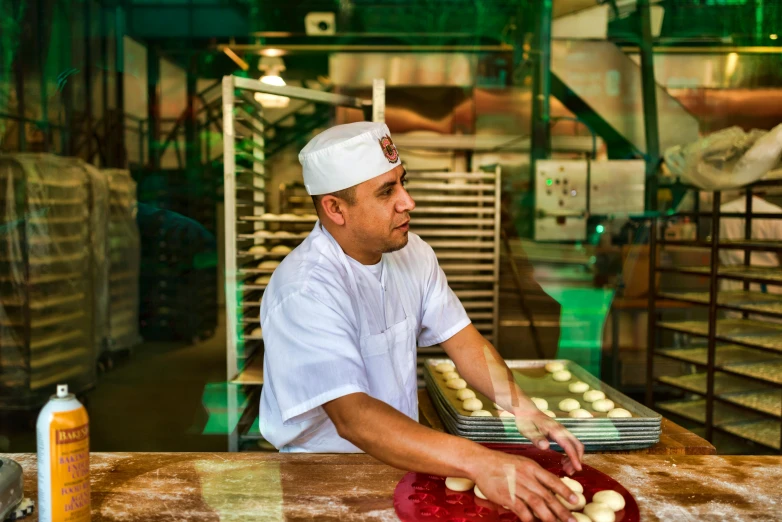 a man that is standing in front of a counter, steamed buns, amr elshamy, in a factory, profile image